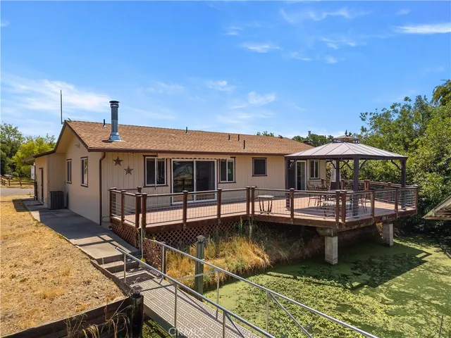 a view of swimming pool with outdoor seating and a garden