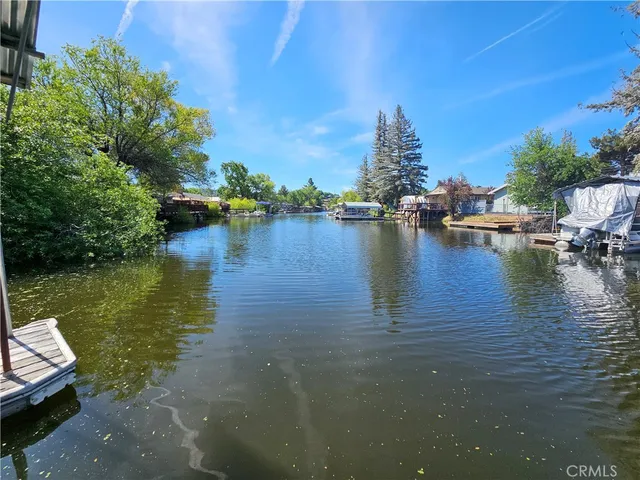 a view of a lake with boats and trees in the background