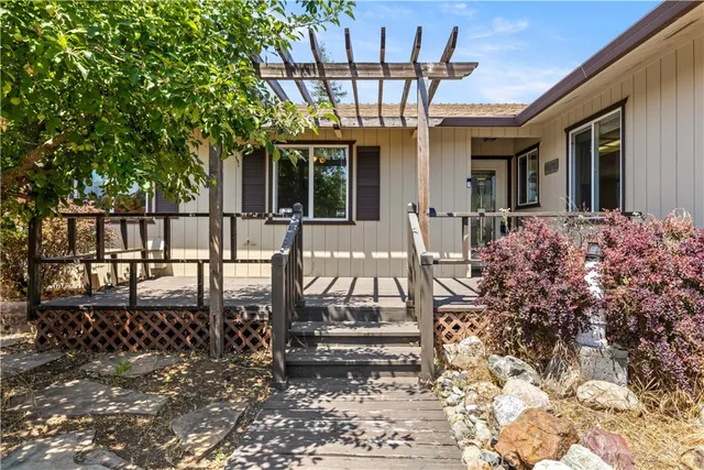 a view of a balcony with chairs and wooden floor