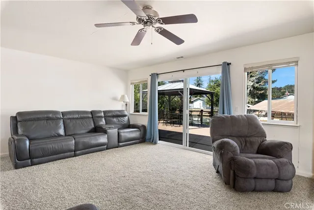 a living room with furniture and a ceiling fan