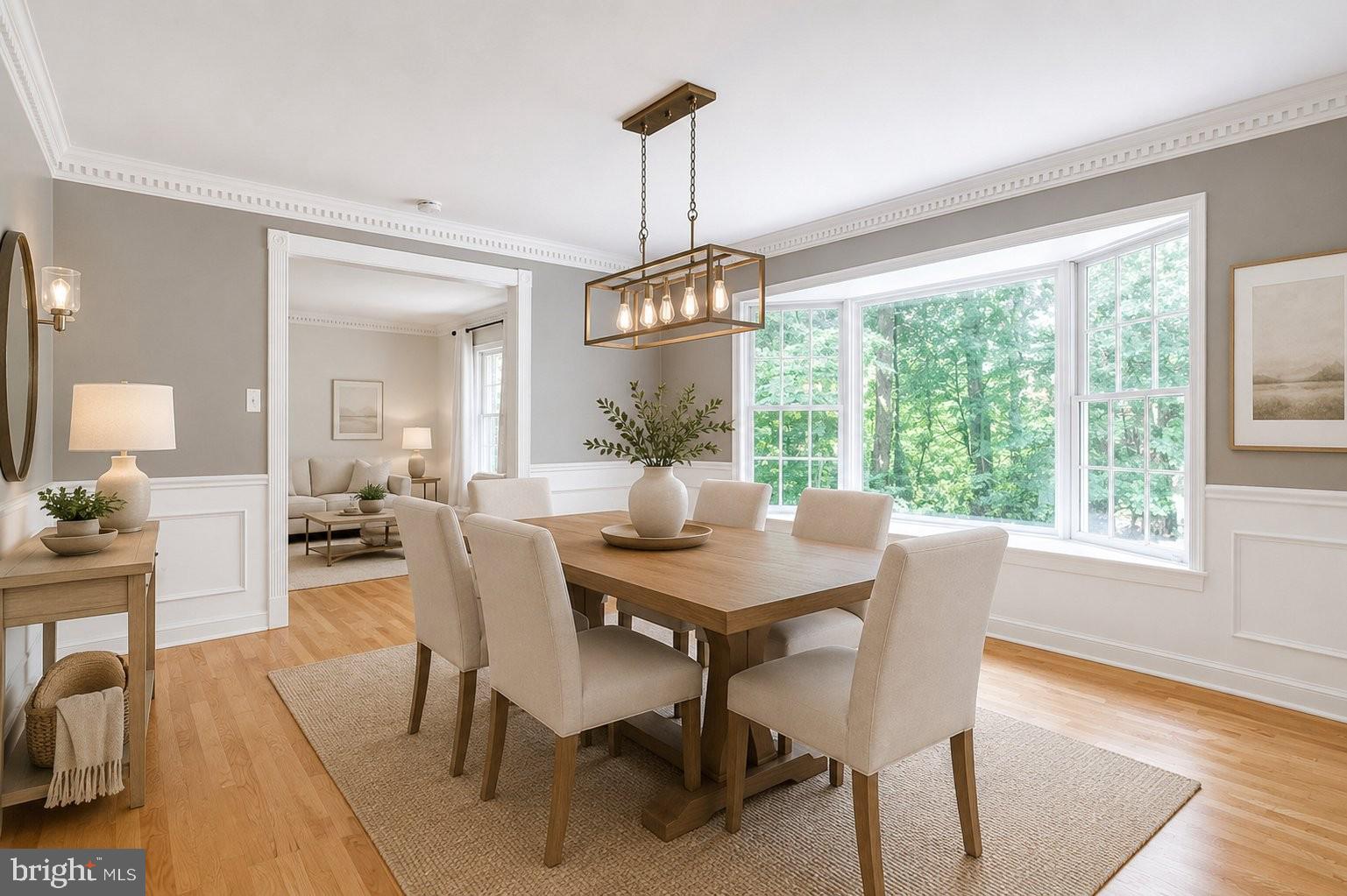 8500 Brook Road McLean, VA 22102 - Photo 9 of 59 a dining room with furniture wooden floor a rug a potted plant and a chandelier