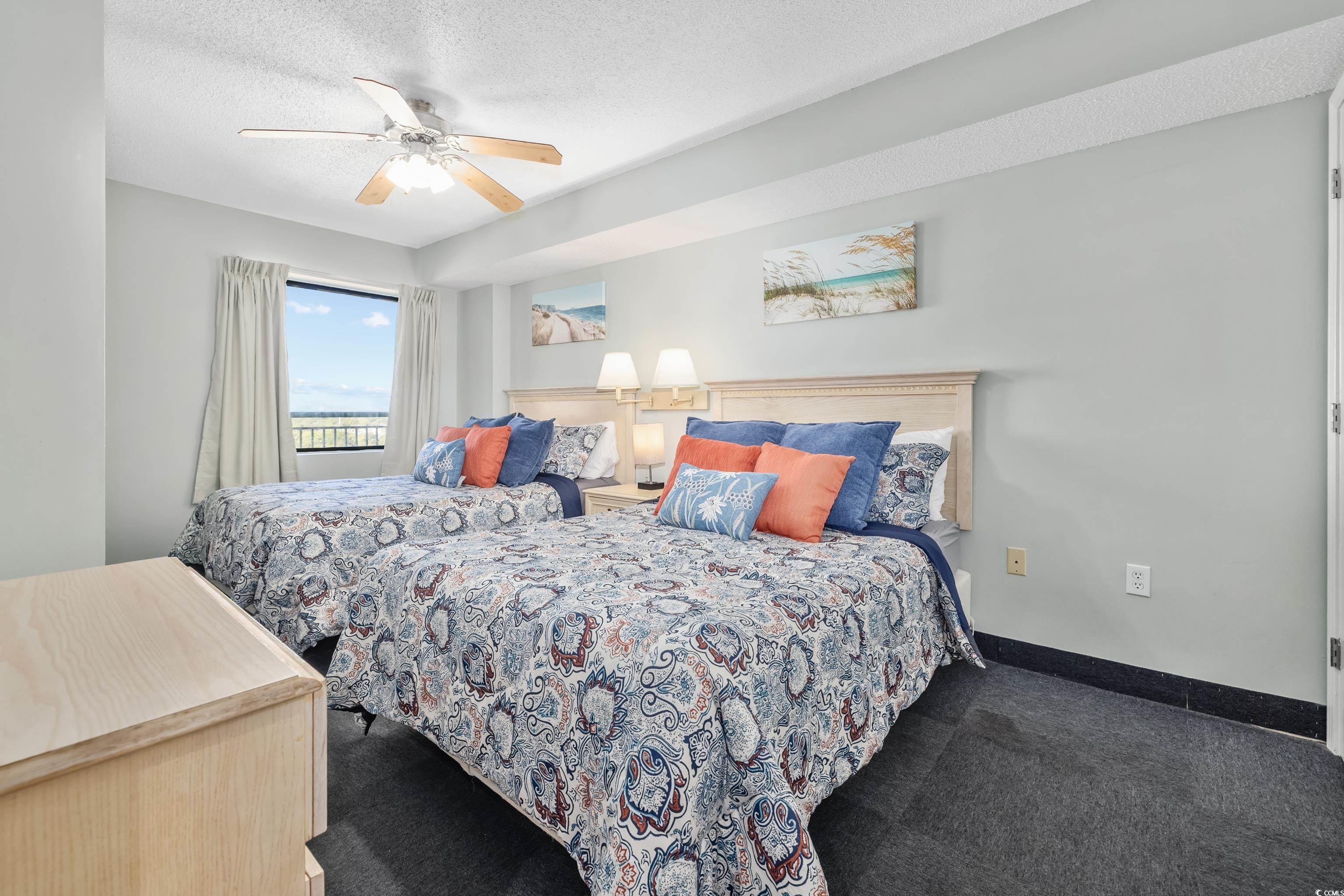 205 74th Avenue North, Unit 1104 Myrtle Beach, SC 29572 - Photo 11 of 40 Bedroom featuring a textured ceiling, ceiling fan, and carpet floors