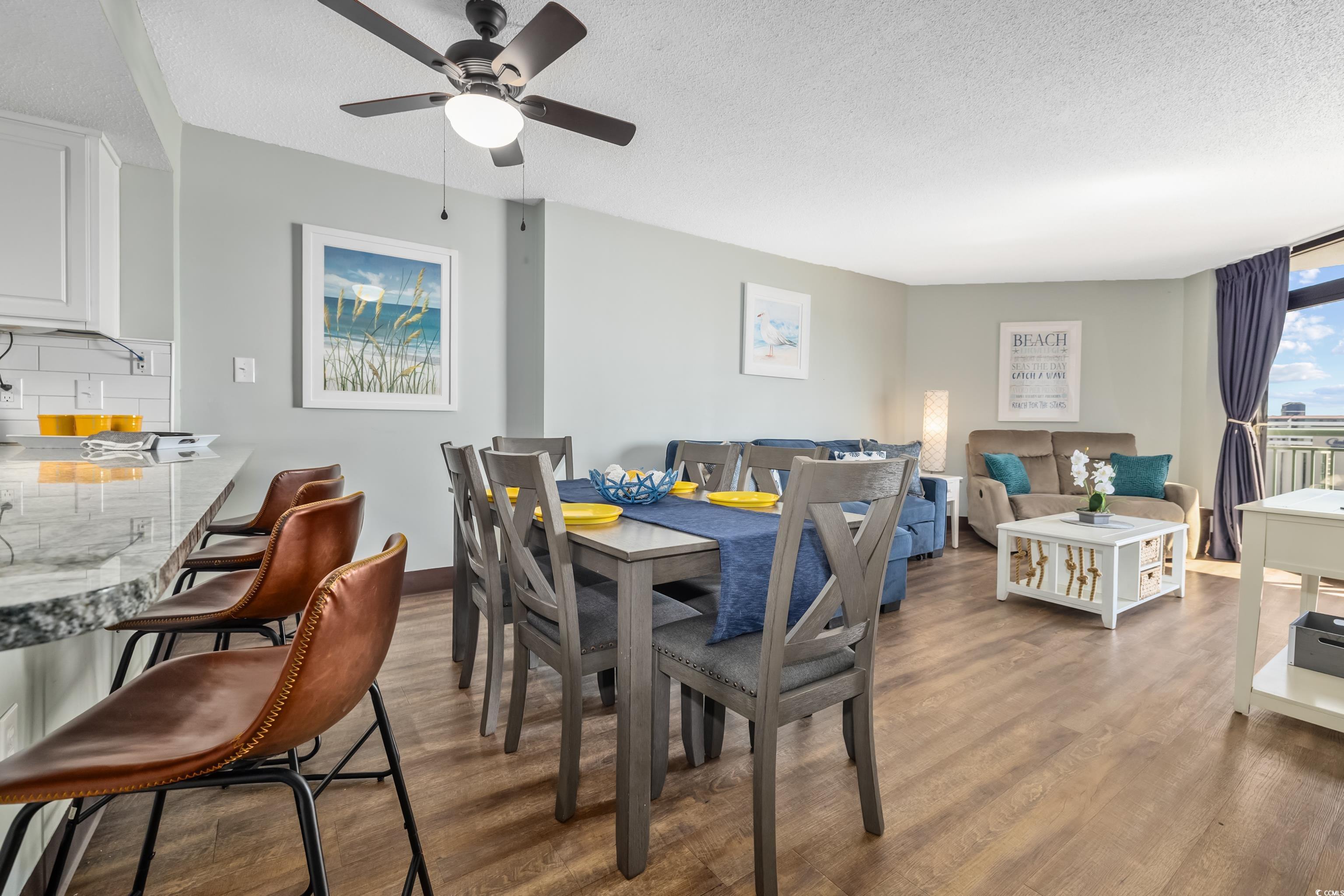 205 74th Avenue North, Unit 1104 Myrtle Beach, SC 29572 - Photo 18 of 40 Dining area with a textured ceiling and dark wood-style flooring