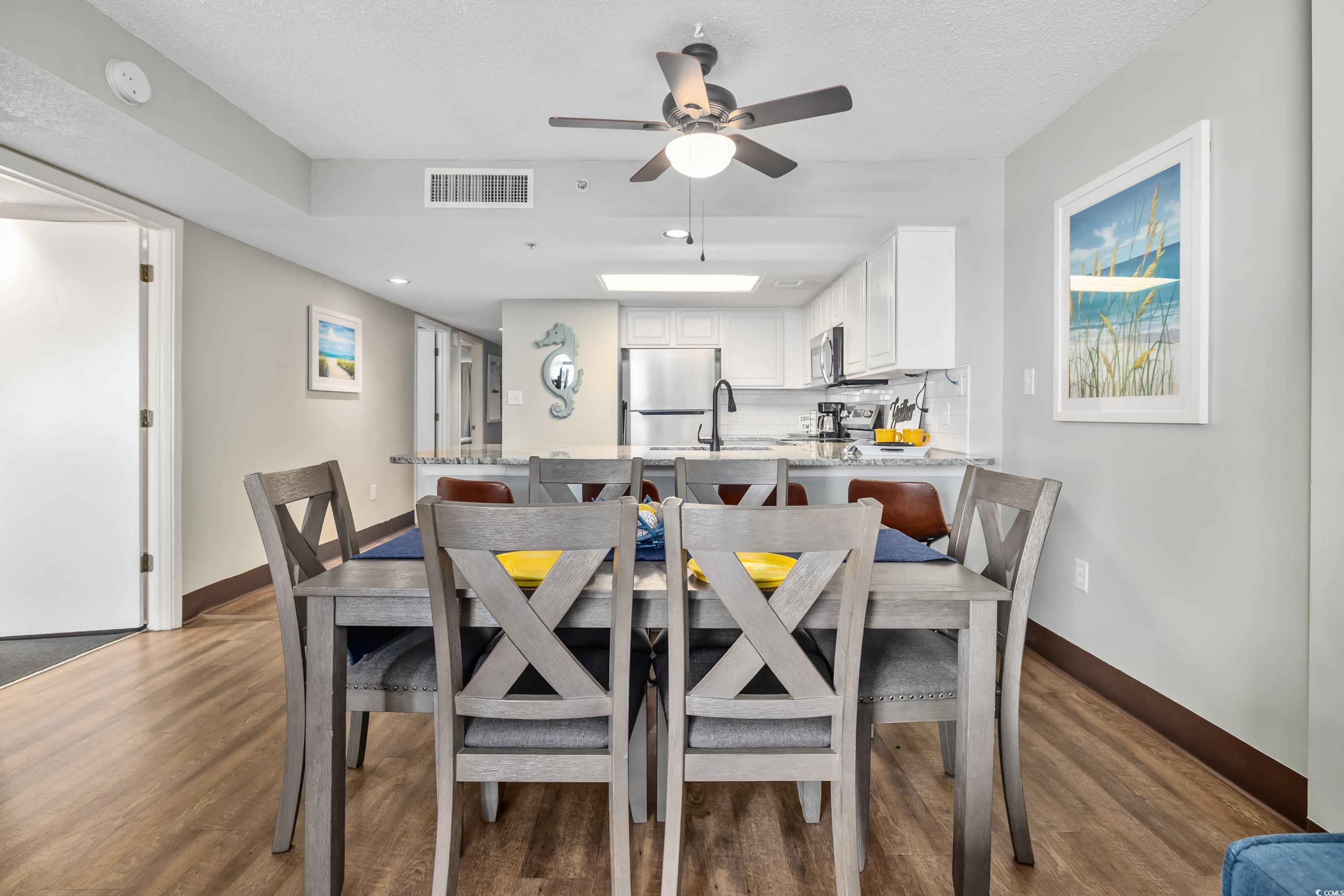 205 74th Avenue North, Unit 1104 Myrtle Beach, SC 29572 - Photo 20 of 40 Dining space with dark wood-type flooring and ceiling fan