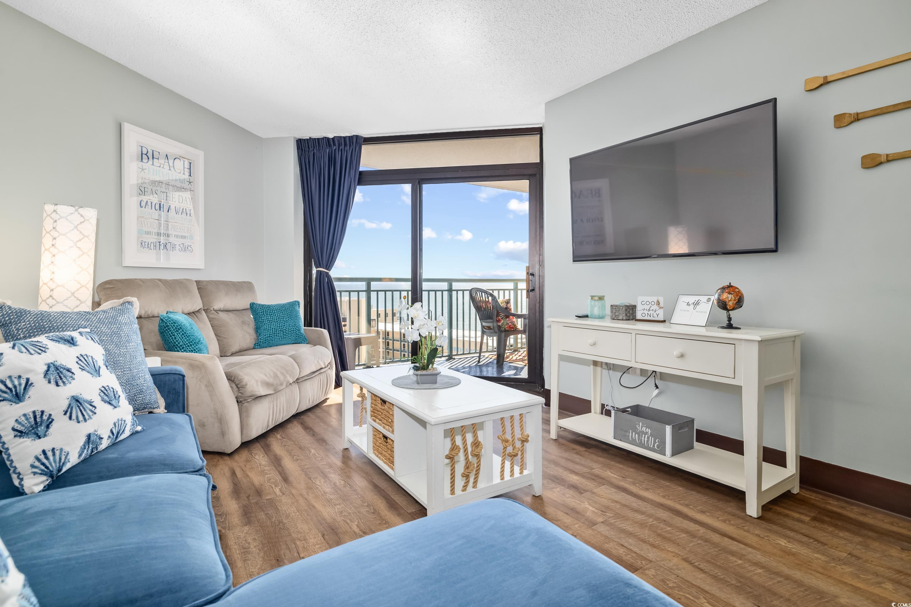 205 74th Avenue North, Unit 1104 Myrtle Beach, SC 29572 - Photo 22 of 40 Living room with wood finished floors and a textured ceiling