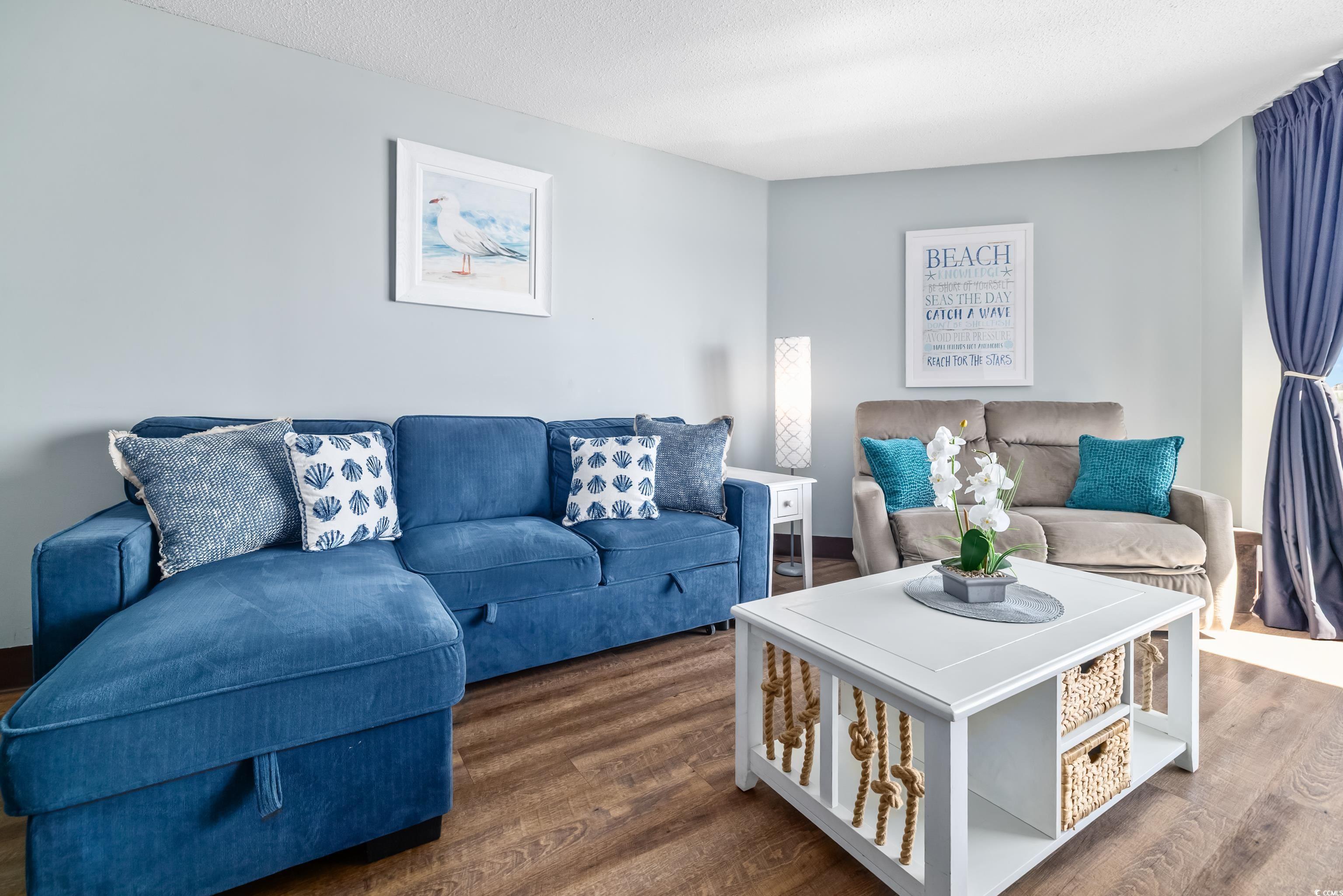 205 74th Avenue North, Unit 1104 Myrtle Beach, SC 29572 - Photo 23 of 40 Living room with wood finished floors and a textured ceiling