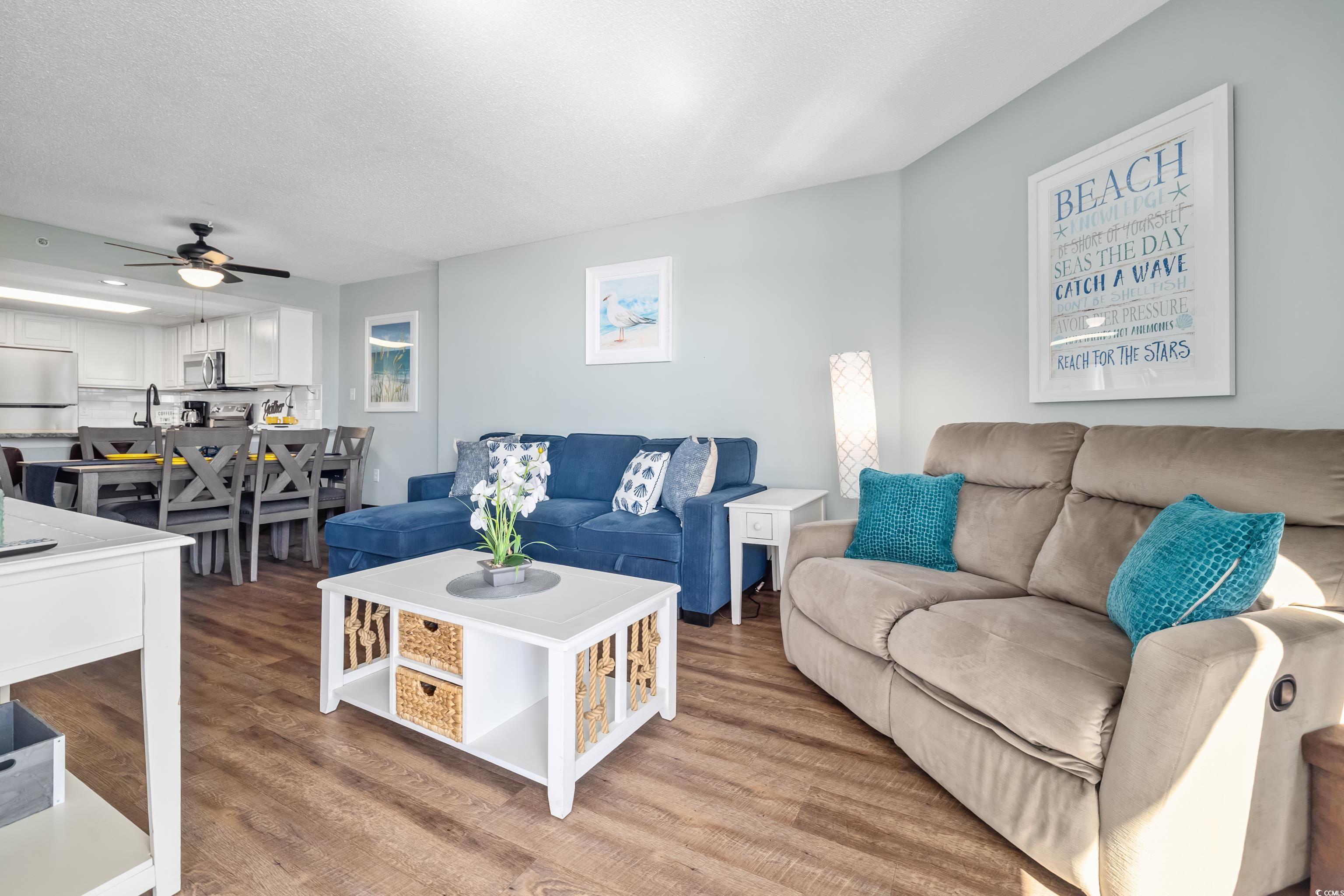 205 74th Avenue North, Unit 1104 Myrtle Beach, SC 29572 - Photo 24 of 40 Living area featuring wood finished floors, a ceiling fan, and a textured ceiling