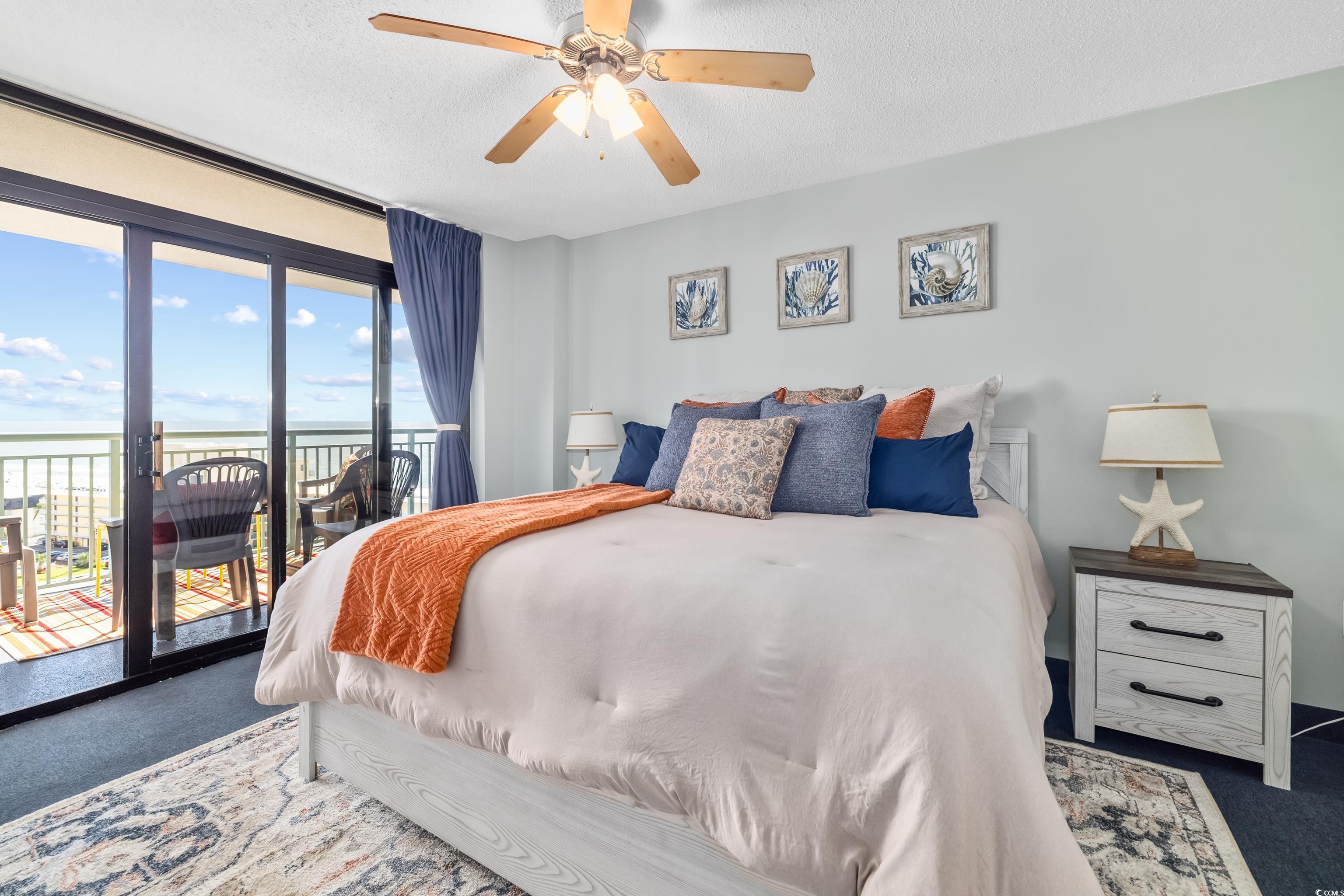205 74th Avenue North, Unit 1104 Myrtle Beach, SC 29572 - Photo 28 of 40 Carpeted bedroom featuring a textured ceiling, access to outside, ceiling fan, and a water view