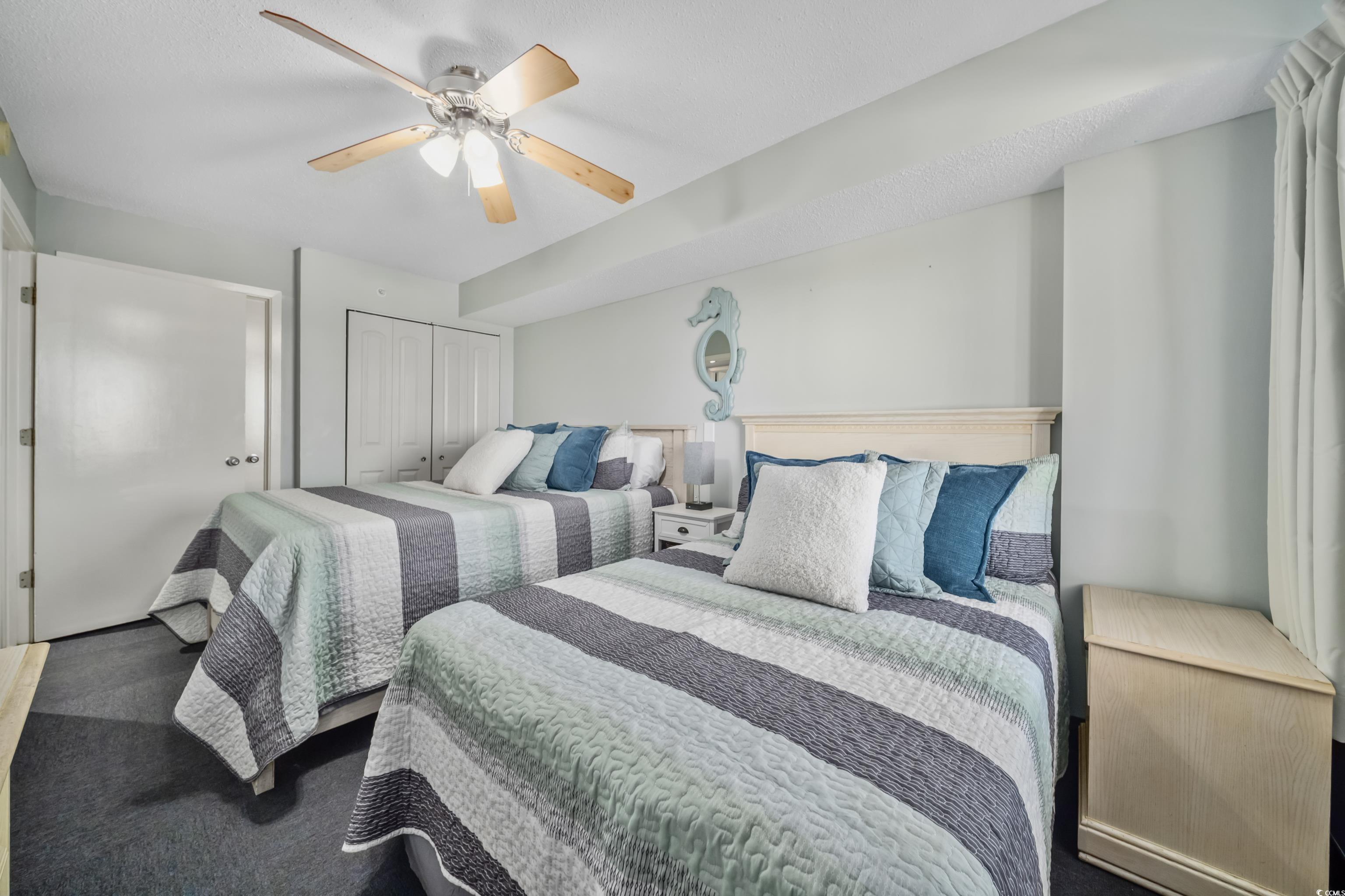 205 74th Avenue North, Unit 1104 Myrtle Beach, SC 29572 - Photo 10 of 40 Carpeted bedroom with a ceiling fan and a closet