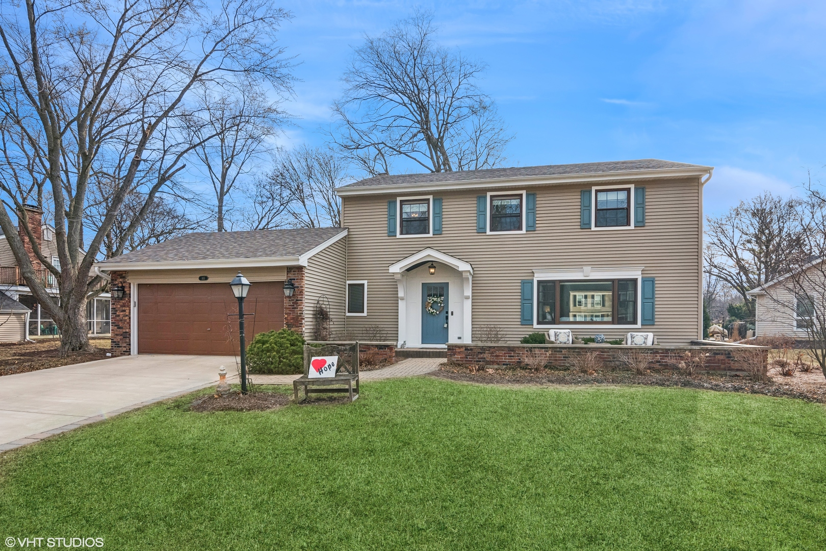 a front view of house with yard and green space