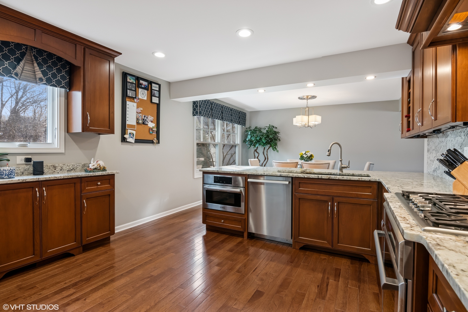 165 Hamilton Lane Wheaton, IL 60189 - Photo 16 of 45 a kitchen with stainless steel appliances granite countertop a stove cabinets and wooden floor