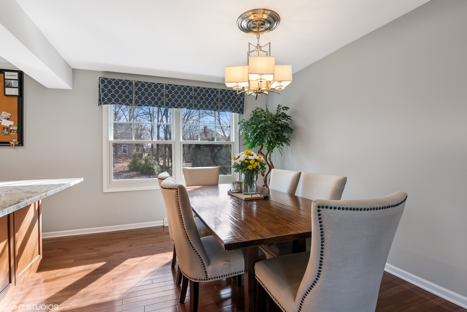 165 Hamilton Lane Wheaton, IL 60189 - Photo 10 of 45 a view of a dining room with furniture a chandelier and wooden floor