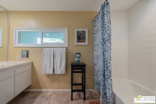 a bathroom with a sink a mirror and a shower