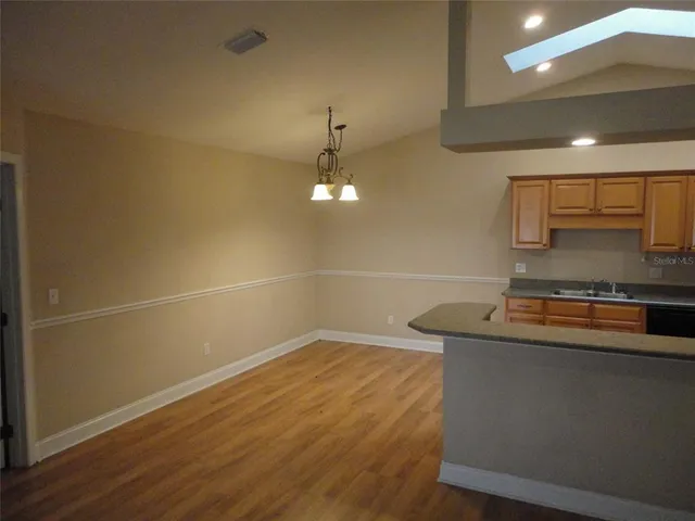 a room with a sink and chandelier