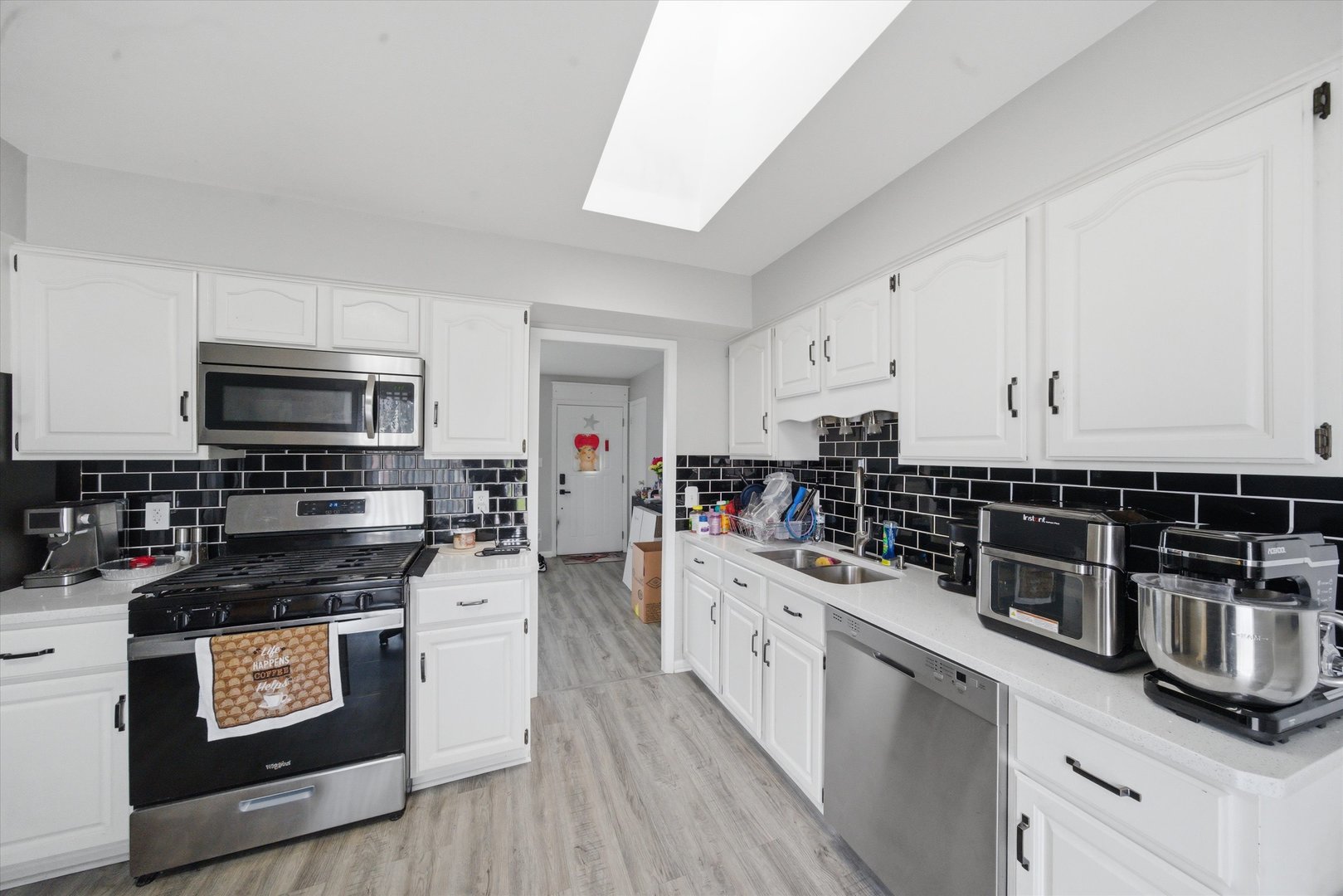 110 Villa Road Streamwood, IL 60107 - Photo 5 of 19 a kitchen with stainless steel appliances a stove sink and cabinets