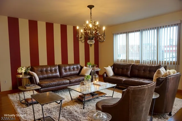 a living room with furniture and a chandelier