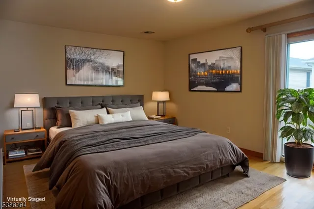 a bedroom with bed and painting on the wall