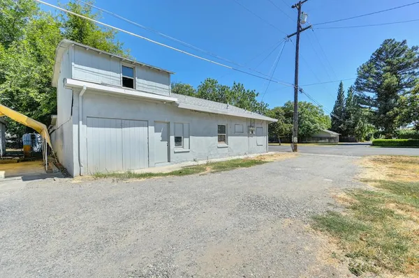 a view of a house with a backyard and garage