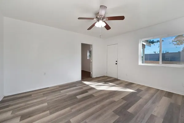 a view of room with ceiling fan and window