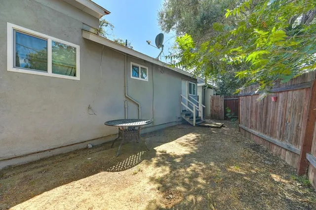 a view of a backyard with a tree