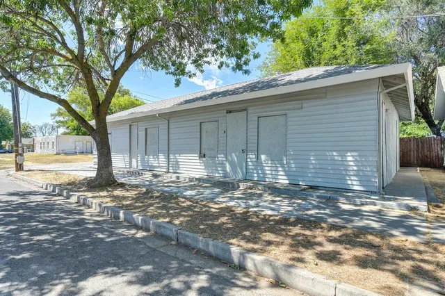 a view of a house with a tree in the background