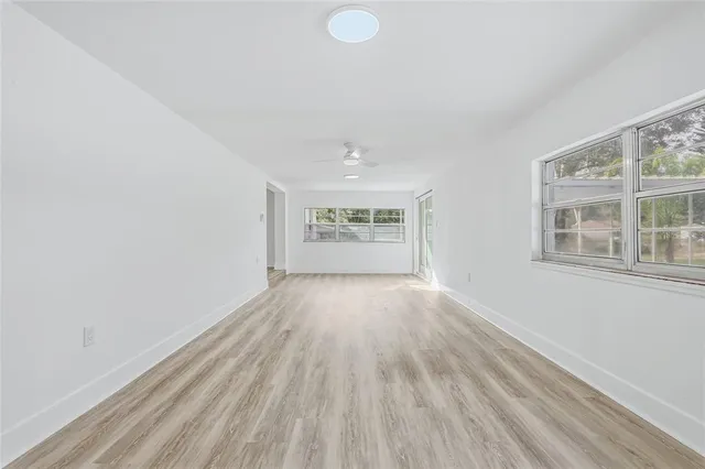 wooden floor in an empty room with a window