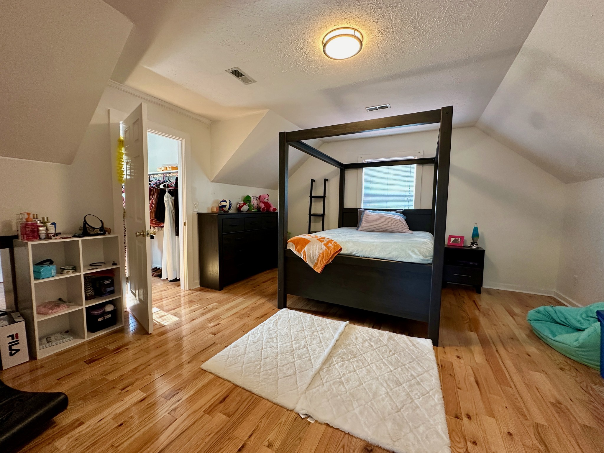 199 Knee Road Watertown, TN 37184 - Photo 25 of 70 a bedroom with a bed and wooden floor