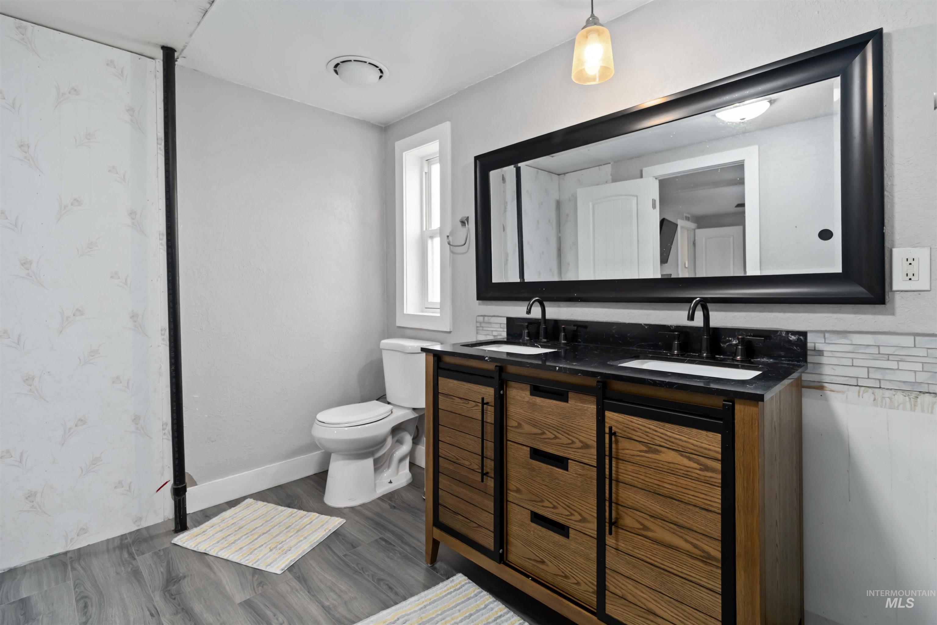 5827 East Little Basin Road King Hill, ID 83633 - Photo 12 of 47 Full bathroom with double vanity and dark wood-style flooring