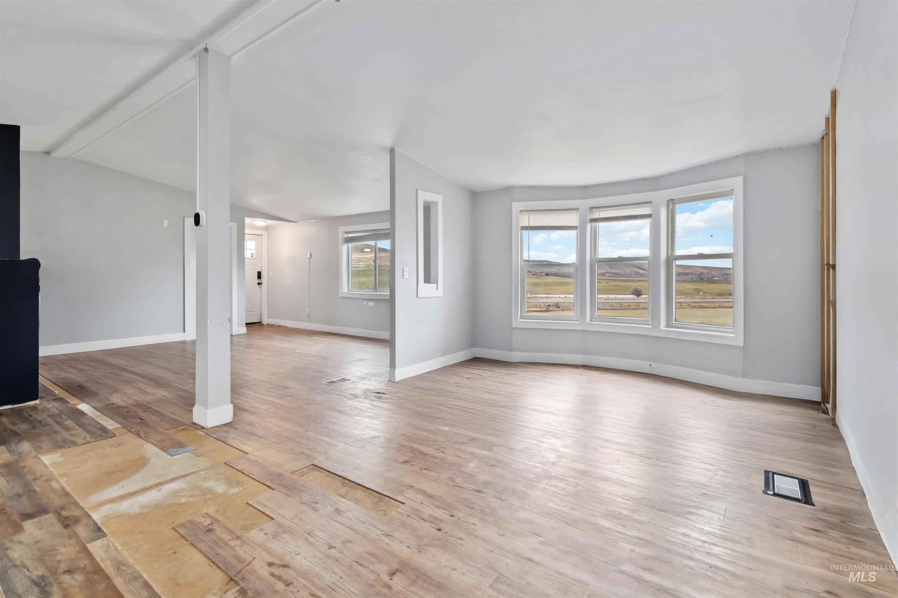 5827 East Little Basin Road King Hill, ID 83633 - Photo 15 of 47 Unfurnished living room with light wood-type flooring and vaulted ceiling