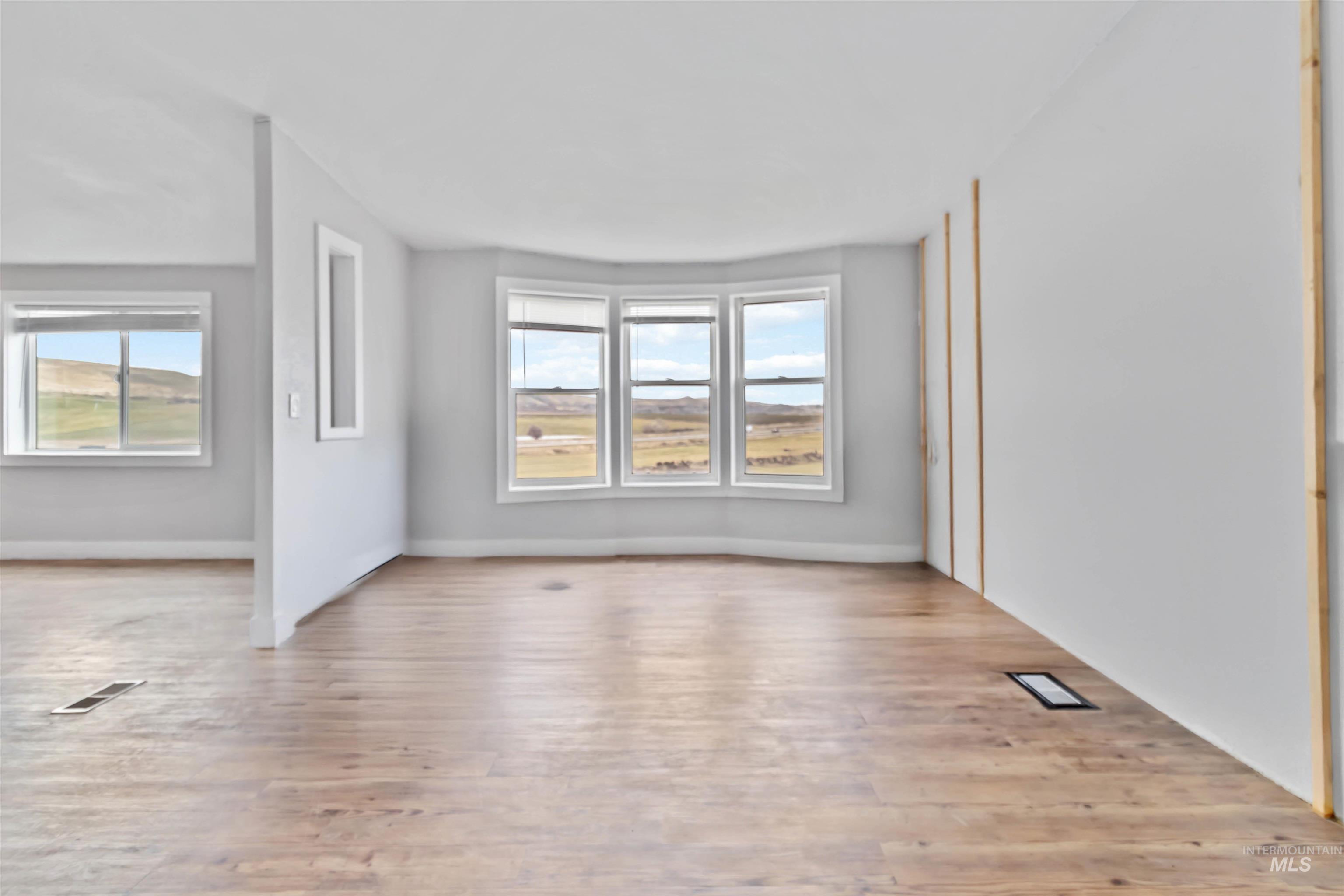 5827 East Little Basin Road King Hill, ID 83633 - Photo 16 of 47 Spare room featuring light wood finished floors and plenty of natural light