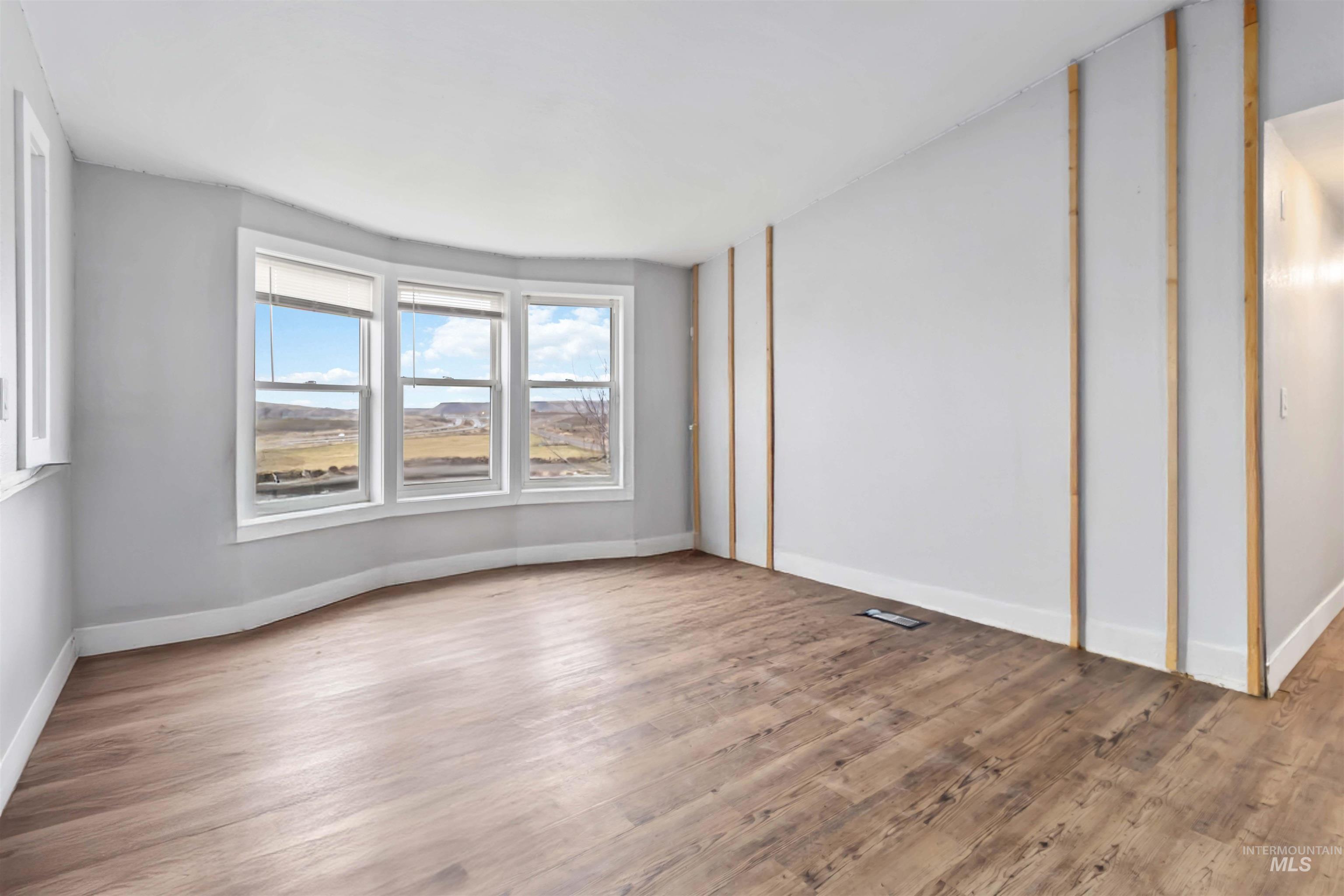 5827 East Little Basin Road King Hill, ID 83633 - Photo 18 of 47 Unfurnished room with wood finished floors and baseboards
