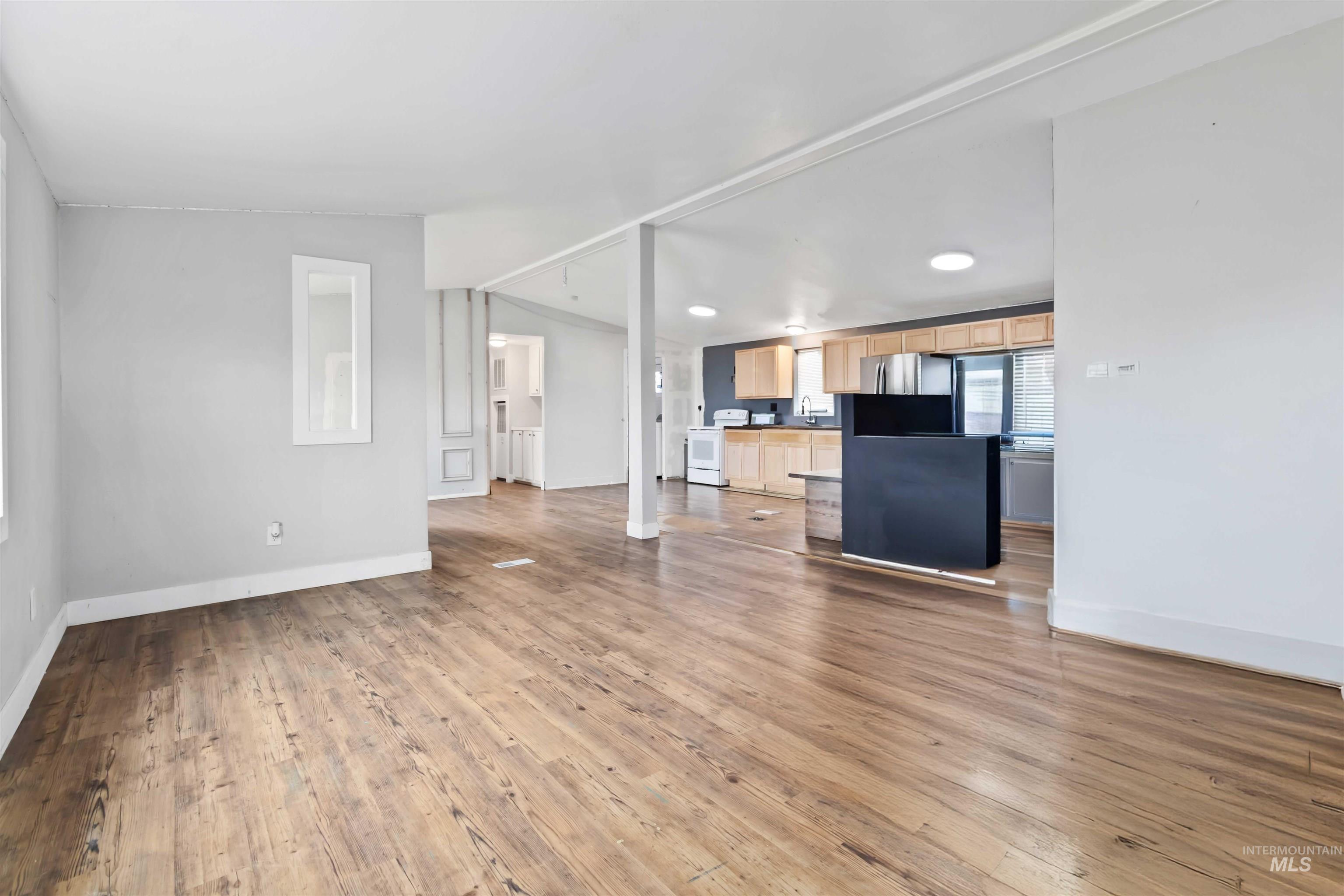 5827 East Little Basin Road King Hill, ID 83633 - Photo 3 of 47 Unfurnished living room featuring light wood-type flooring, lofted ceiling, and recessed lighting