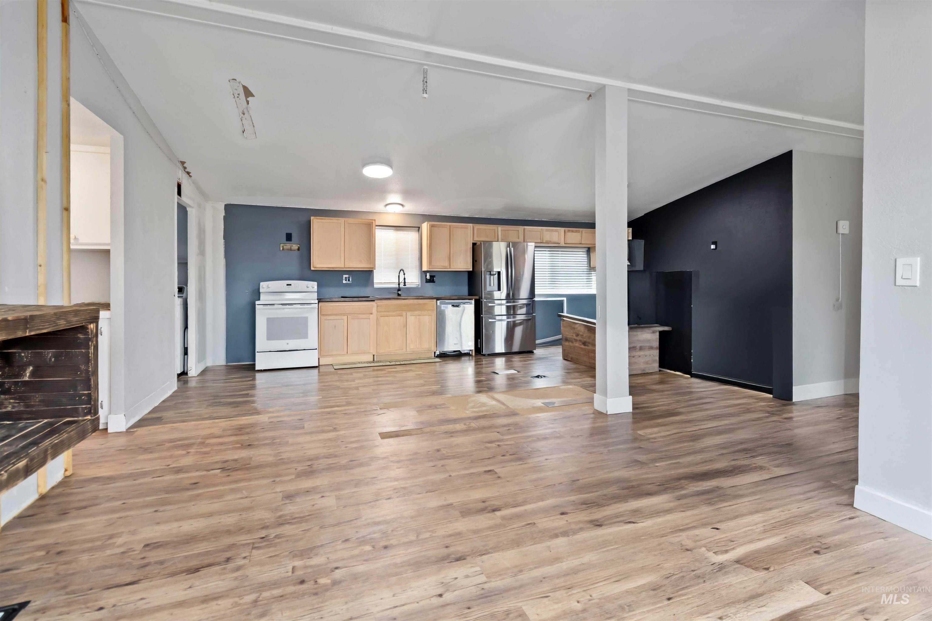 5827 East Little Basin Road King Hill, ID 83633 - Photo 4 of 47 Kitchen with light brown cabinetry, stainless steel appliances, dark countertops, and light wood-style floors