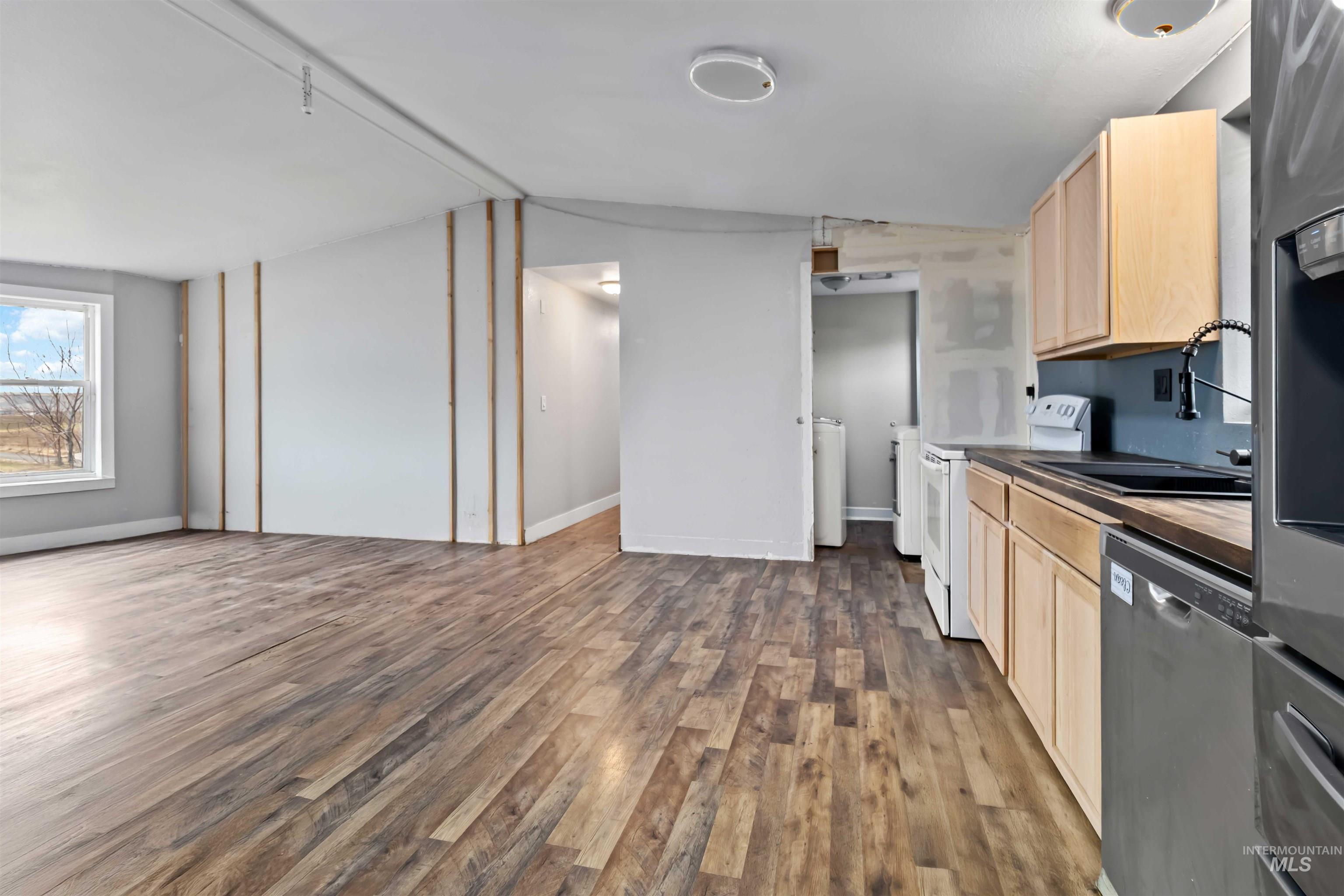 5827 East Little Basin Road King Hill, ID 83633 - Photo 8 of 47 Kitchen with light brown cabinetry, appliances with stainless steel finishes, dark wood-type flooring, vaulted ceiling, and wood counters