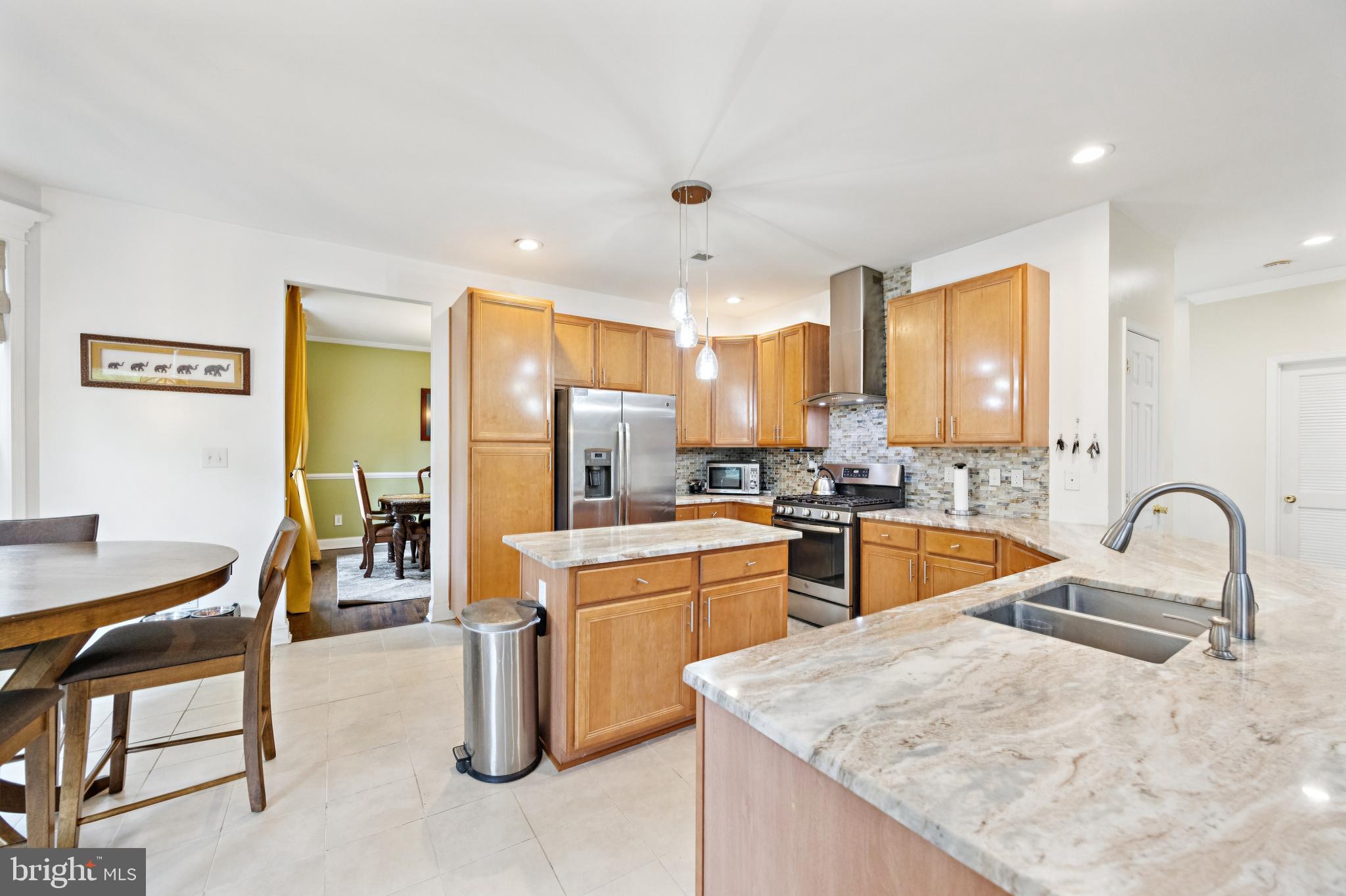 1285 Kearsley Road Sicklerville, NJ 08081 - Photo 3 of 34 a kitchen with sink a refrigerator and chairs