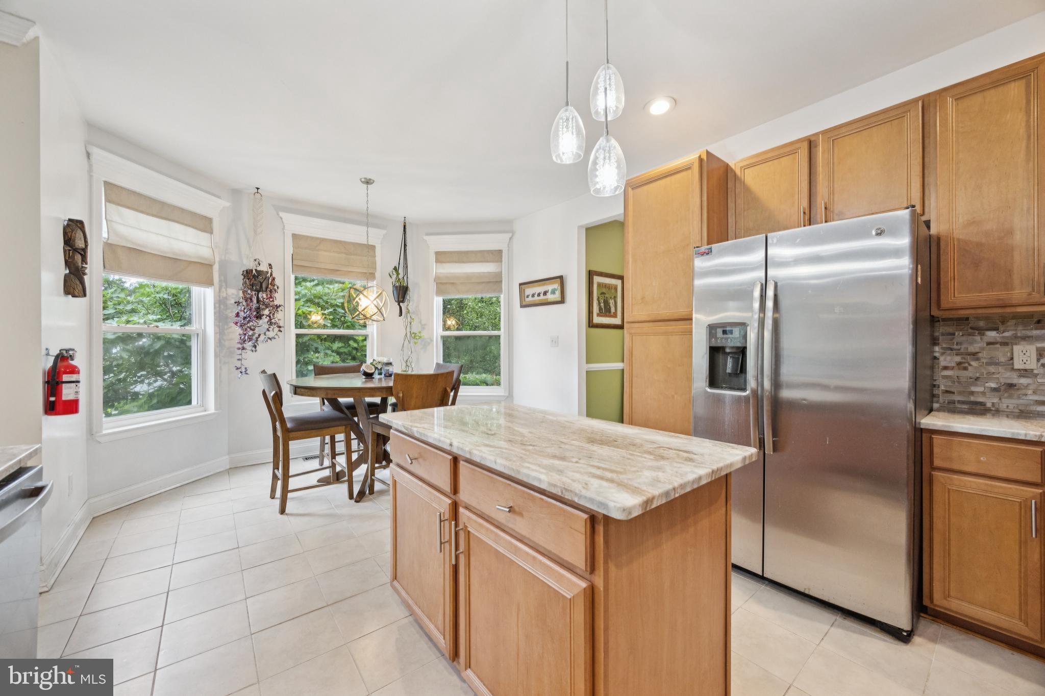 1285 Kearsley Road Sicklerville, NJ 08081 - Photo 34 of 34 a kitchen with a refrigerator a table and chairs in it