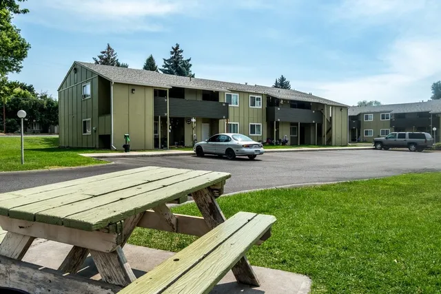 a view of a patio with table and chairs with wooden floor and fence