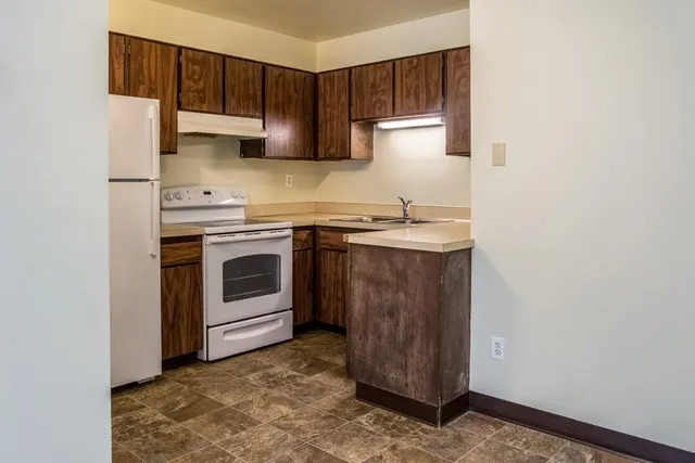 a kitchen with a stove top oven sink and cabinets