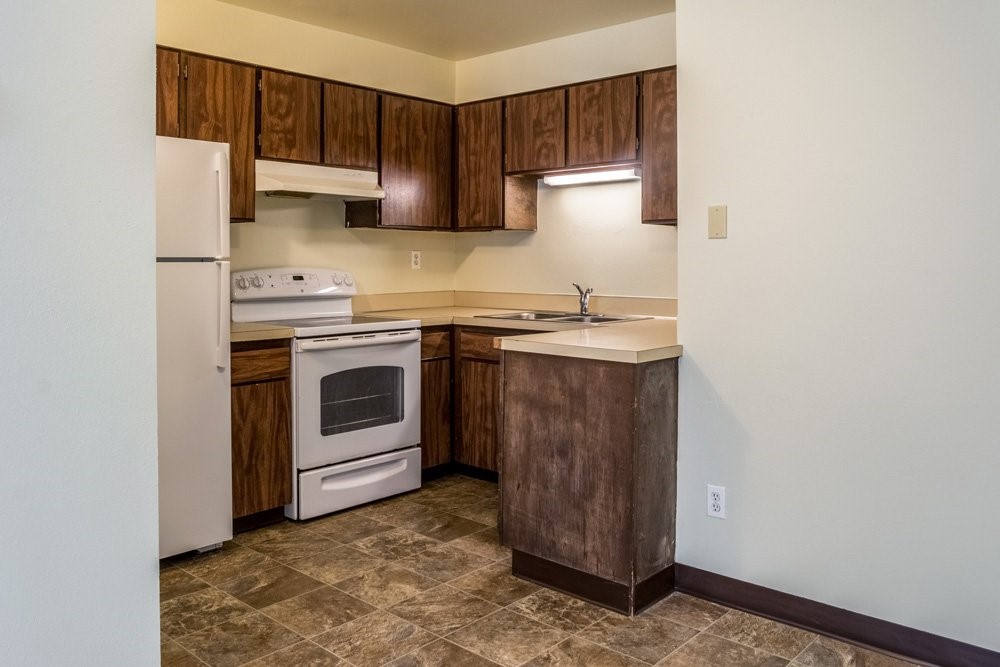 319 Southwest G Street Madras, OR 97741 - Photo 6 of 10 a kitchen with a stove top oven sink and cabinets