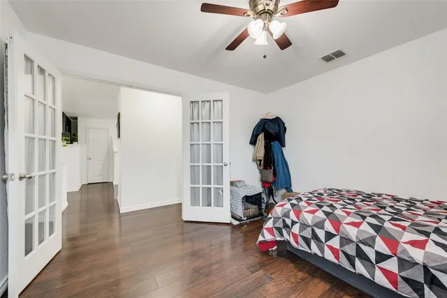 a bedroom with a bed and a chandelier
