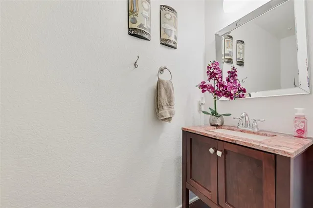 a bathroom with a sink vanity and mirror