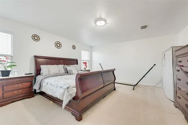 a bedroom with a bed and a dresser