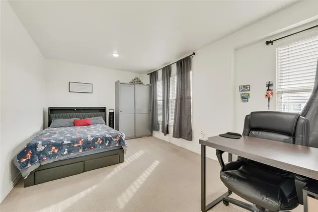 a bedroom with a bed and a desk