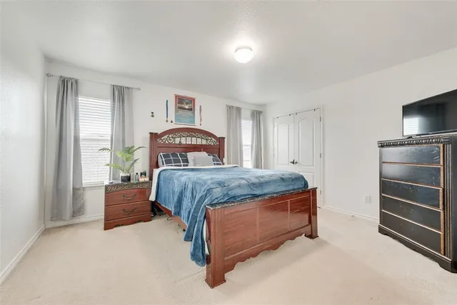 a bedroom with a bed and a television