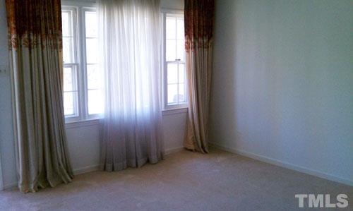 1007 Akron Avenue Durham, NC 27713 - Photo 2 of 8 an empty room with windows