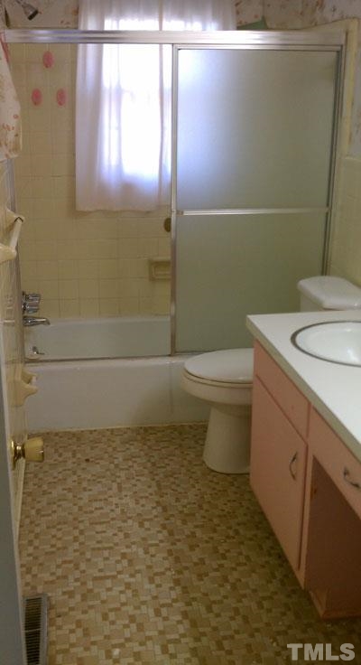 1007 Akron Avenue Durham, NC 27713 - Photo 4 of 8 a bathroom with a sink a toilet and a mirror