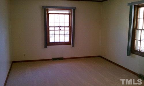 1007 Akron Avenue Durham, NC 27713 - Photo 6 of 8 an empty room with a window