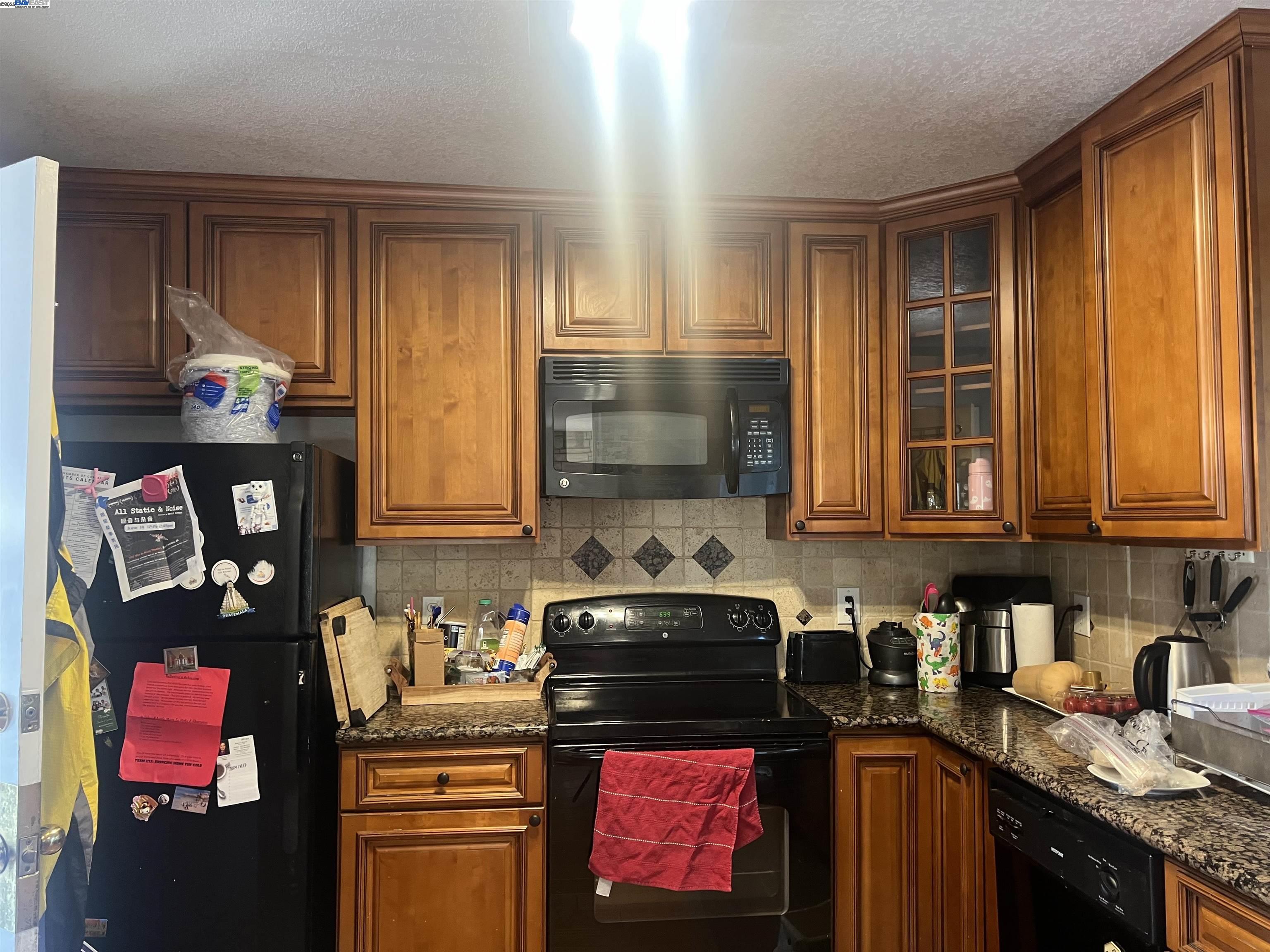 2155 Goldcrest Circle Pleasanton, CA 94566 - Photo 5 of 14 a kitchen with stainless steel appliances granite countertop a stove and cabinets
