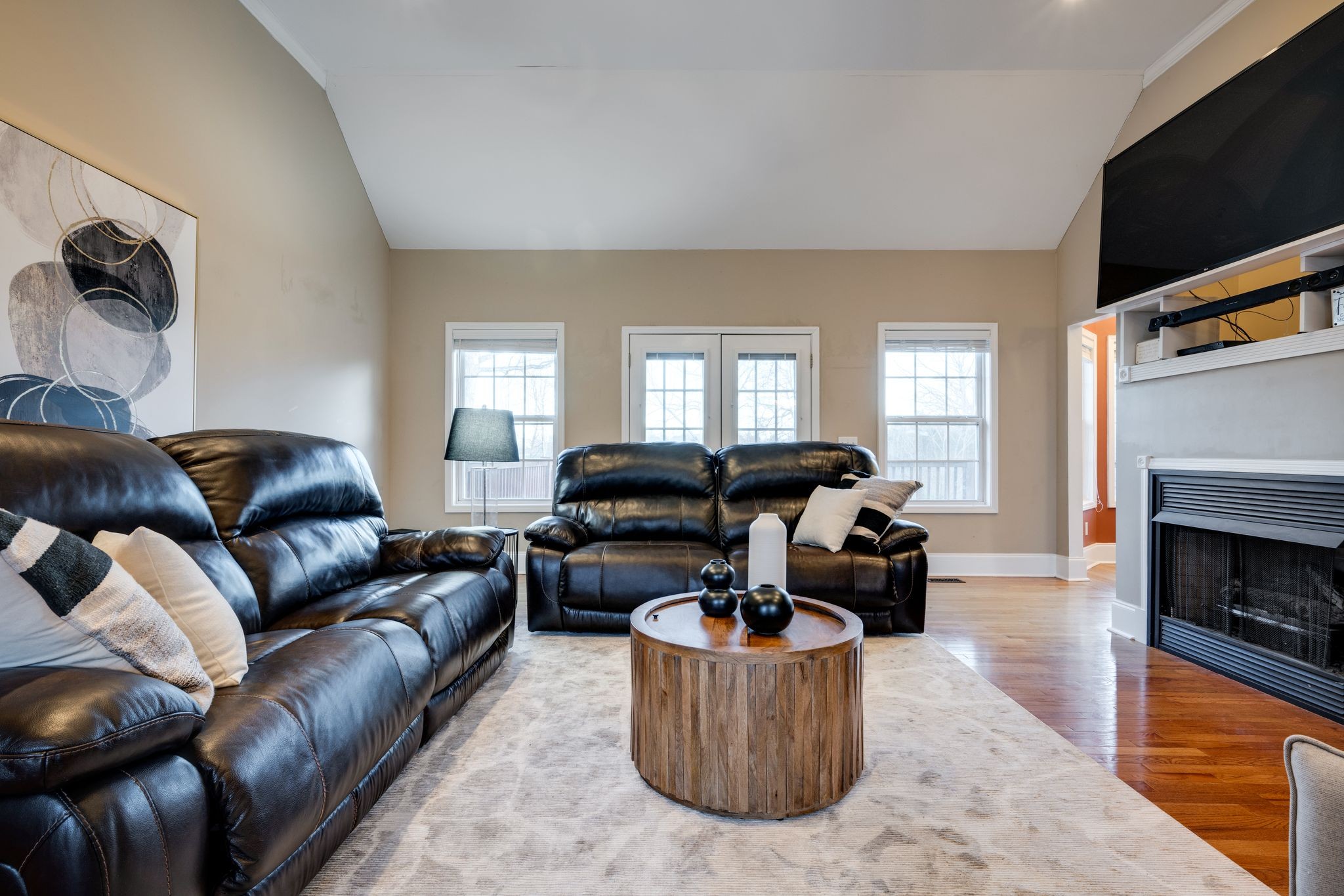 754 Hafner Road Charlotte, TN 37036 - Photo 12 of 54 a living room with furniture a flat screen tv and a fireplace