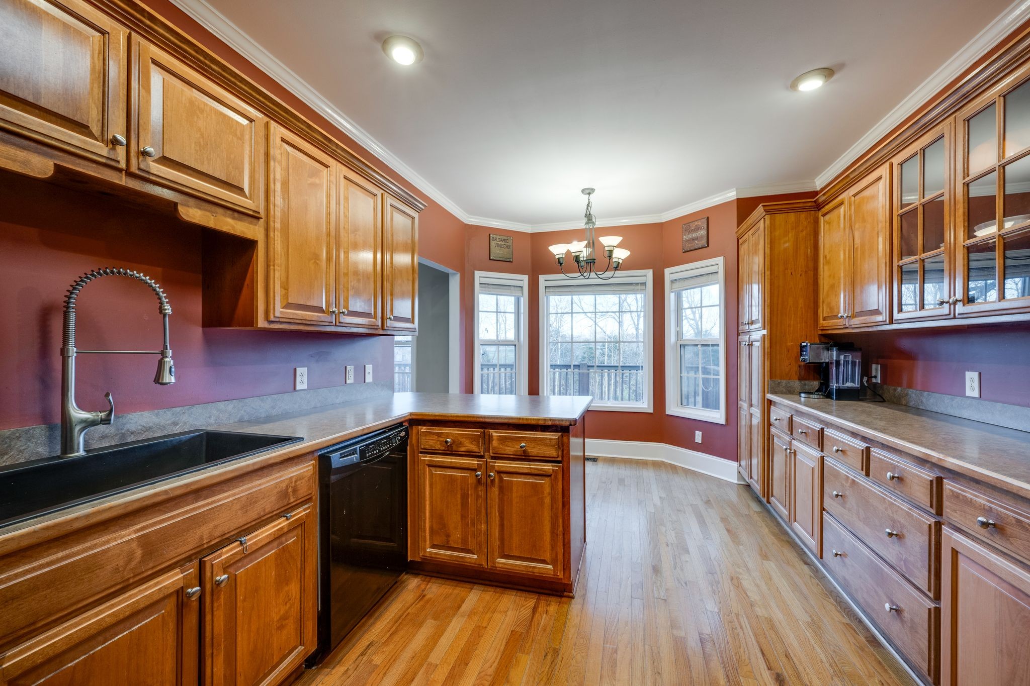 754 Hafner Road Charlotte, TN 37036 - Photo 16 of 54 a kitchen with stainless steel appliances granite countertop lots of counter space and wooden floors